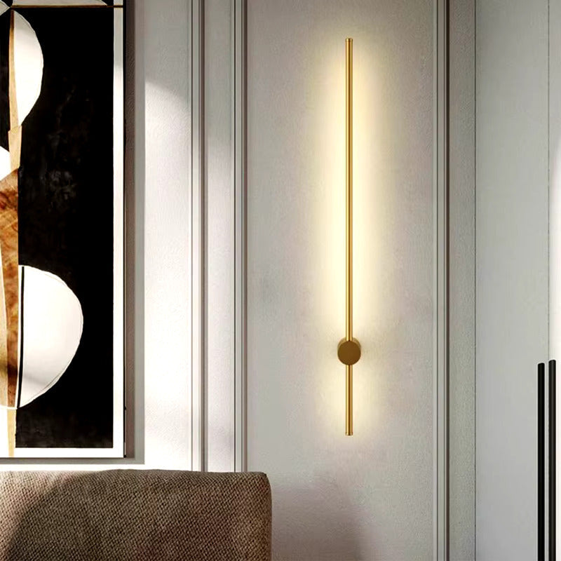 Warm gold LED wall light by Light My House, modern bedroom lounge lamp with sleek design and soft ambient glow.