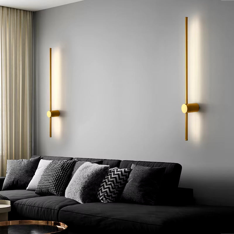 Warm gold LED wall light by Light My House mounted on a modern bedroom wall, providing soft ambient lighting.