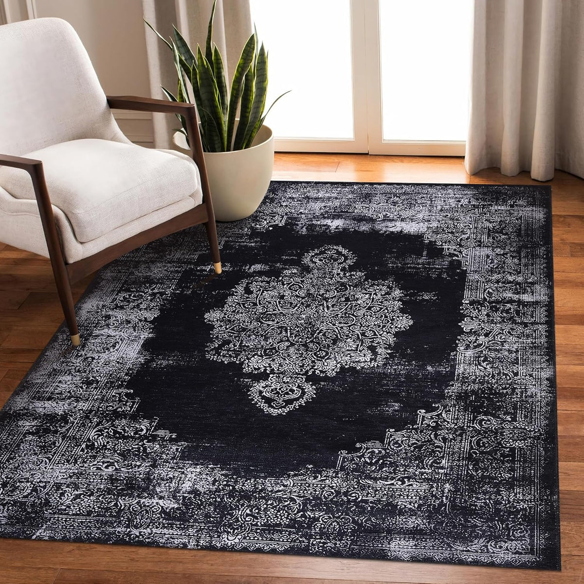 Black and gray medallion washable rug by Netline Home featuring intricate traditional design, perfect for living rooms or bedrooms.