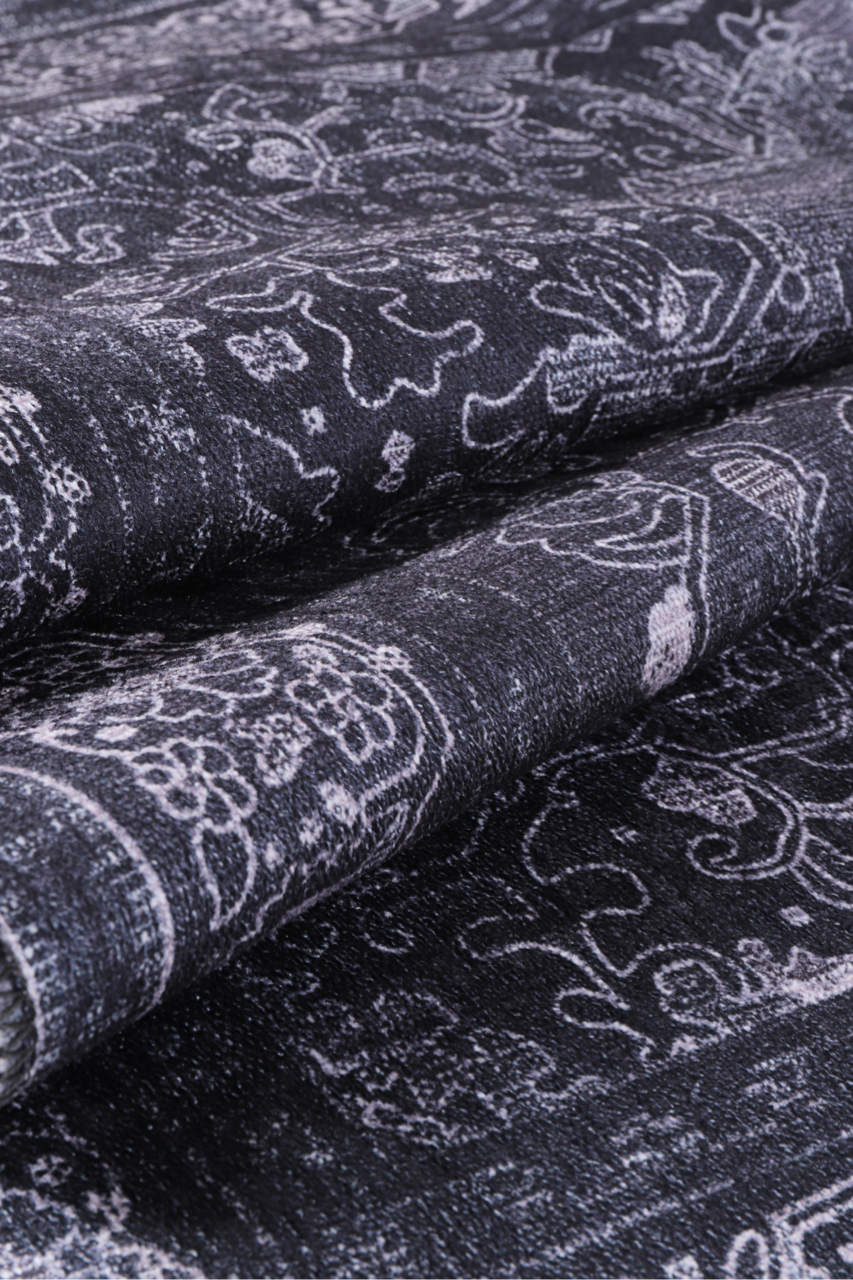 Black tribal geometric medallion washable rug by Netline Home, featuring bold patterns and a durable design.