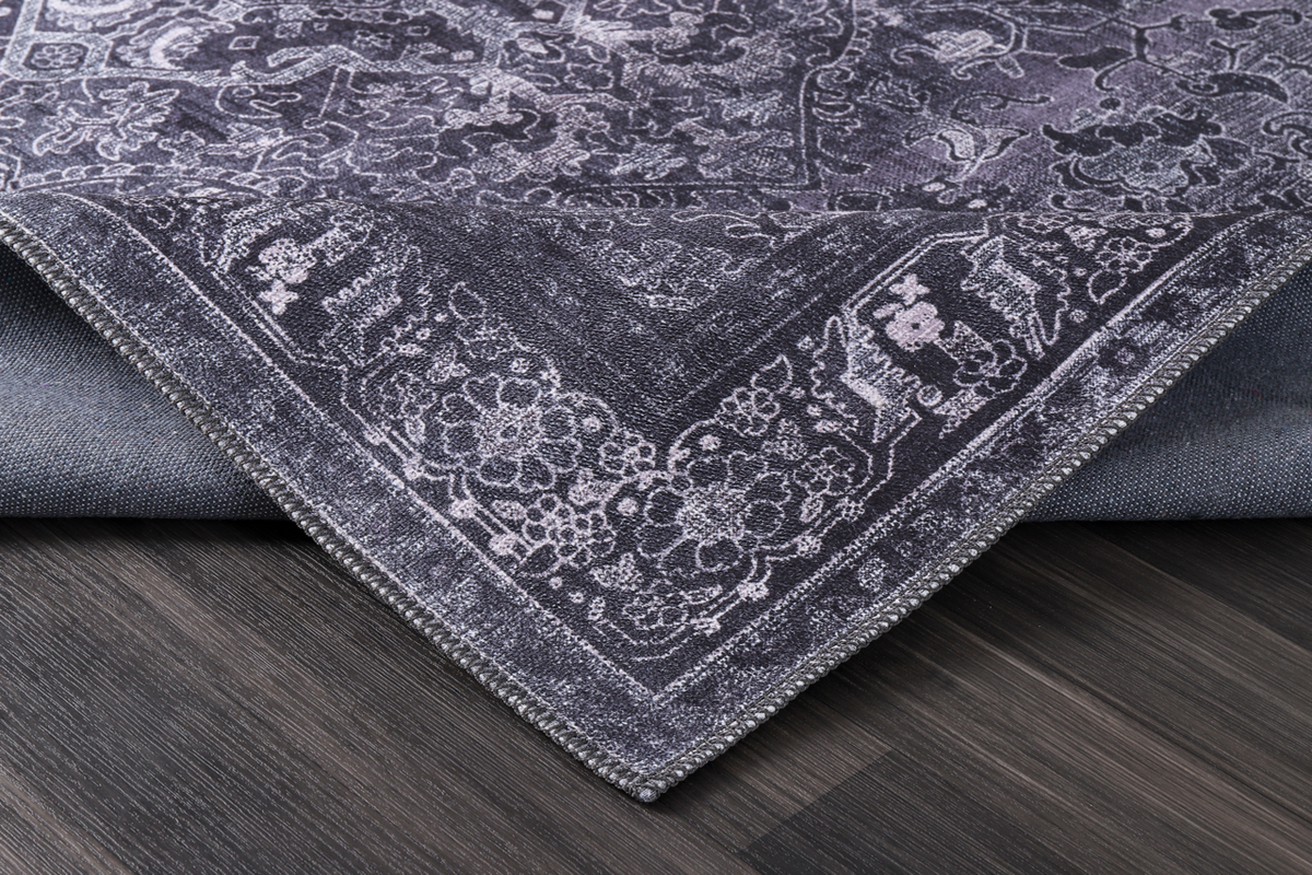 Black geometric tribal washable rug with medallion design from Netline Home, featuring bold patterns and vibrant colors.