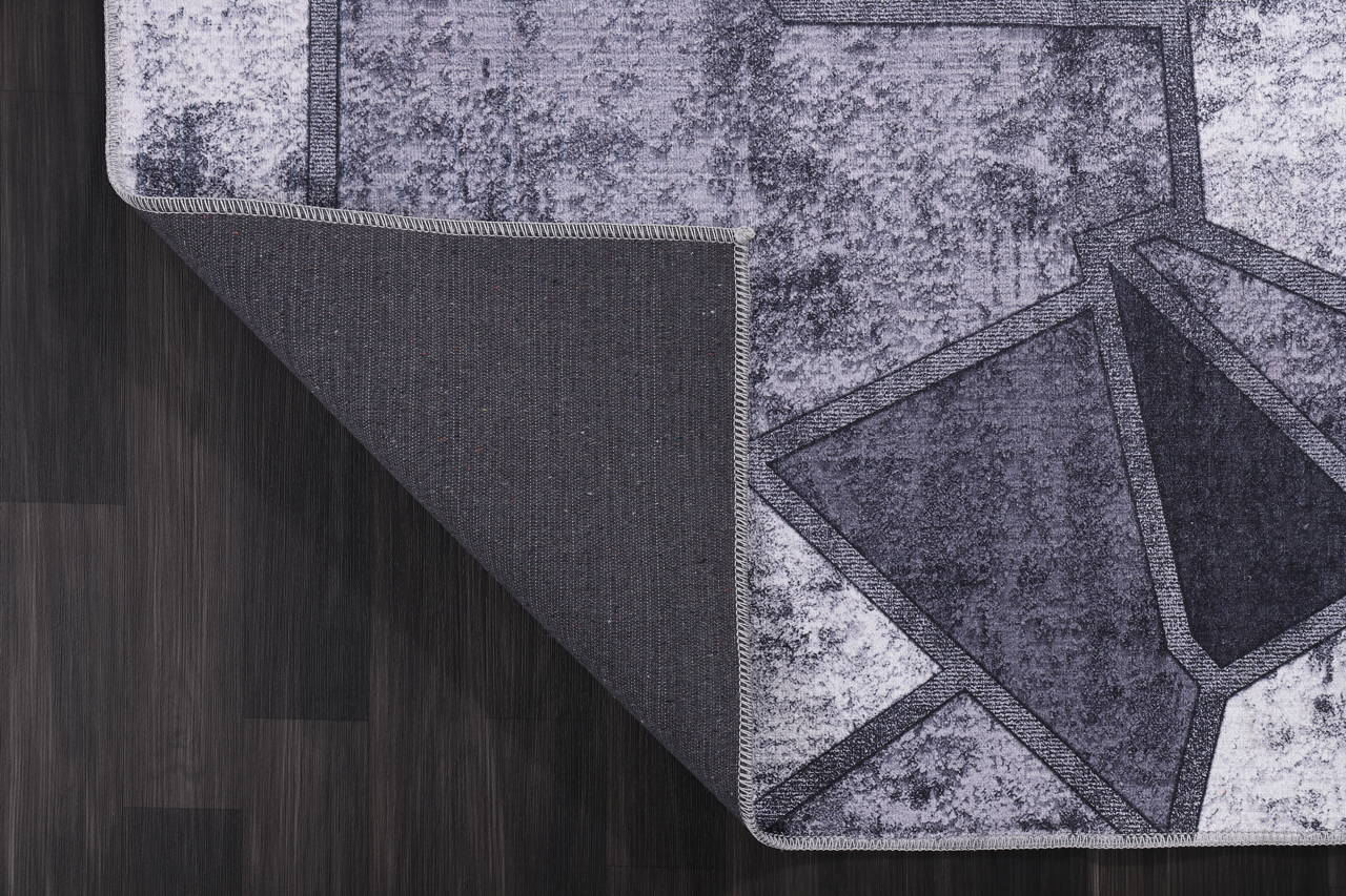 Geometric black and white patchwork washable rug by Netline Home, featuring bold pattern and modern design.