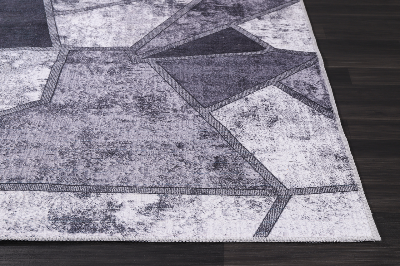 Black and white geometric patchwork washable rug by Netline Home, featuring a modern design and soft, durable fabric.