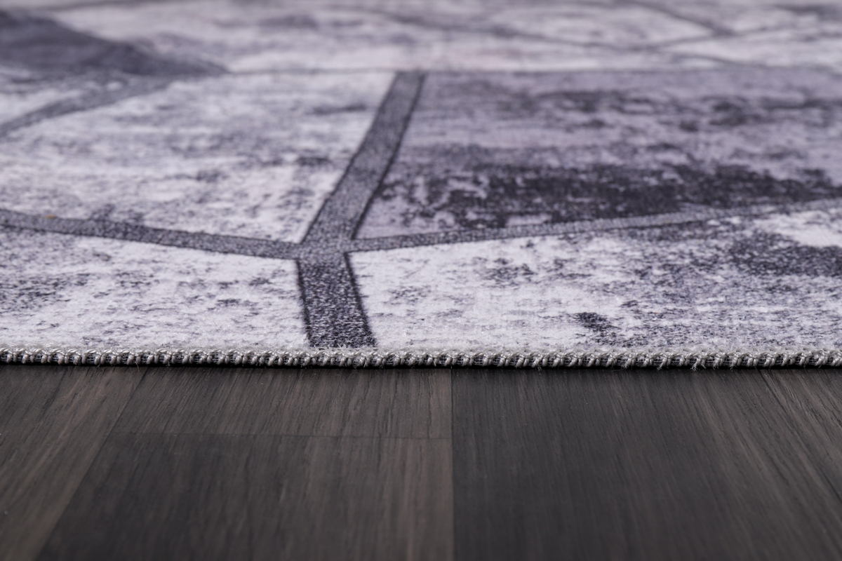 Black and white geometric patchwork washable rug by Netline Home featuring modern design and bold pattern.