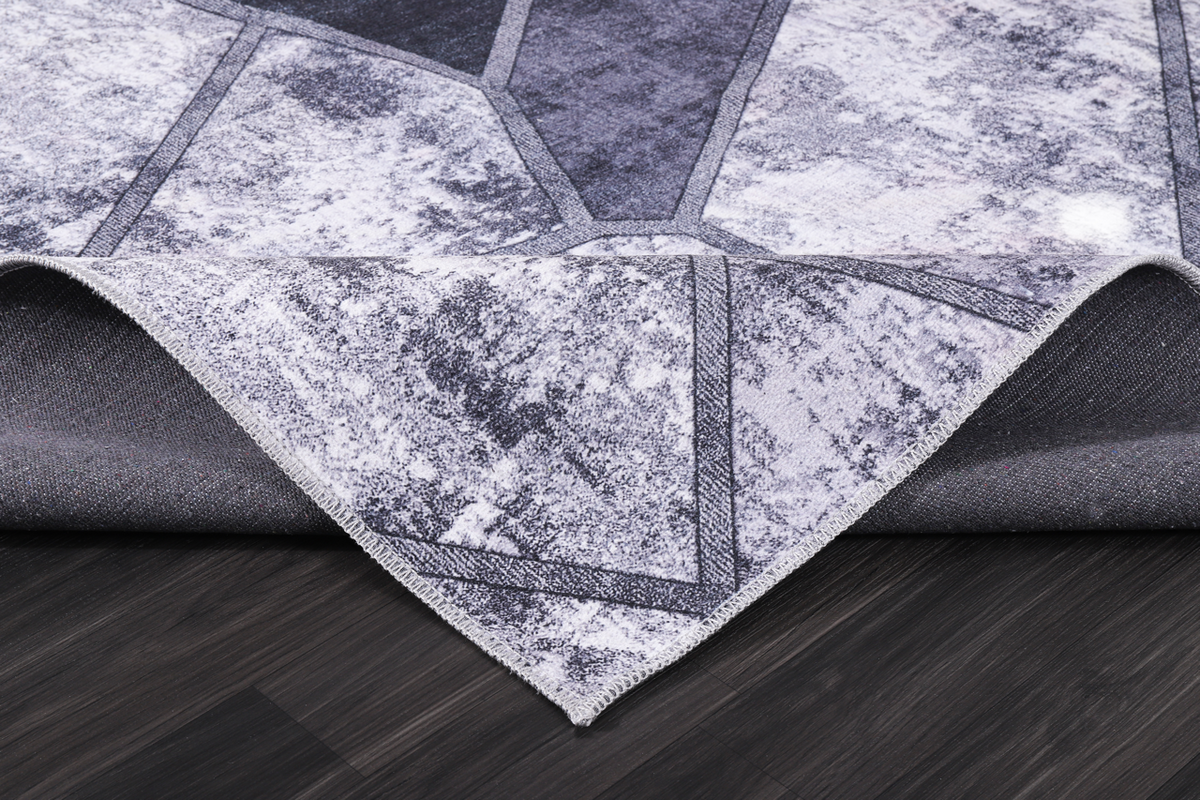 Black and white geometric patchwork washable rug by Netline Home, featuring modern, bold pattern and soft textile texture.