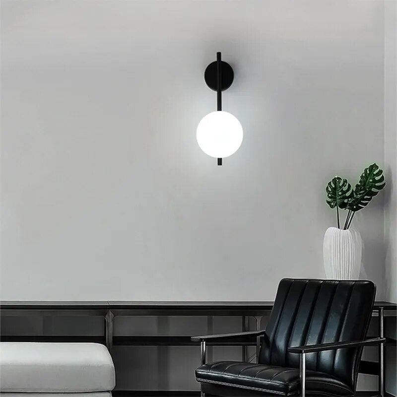 Modern black globe wall lamp by Light My House with a minimalist glass shade, mounted on a wall for stylish lighting.