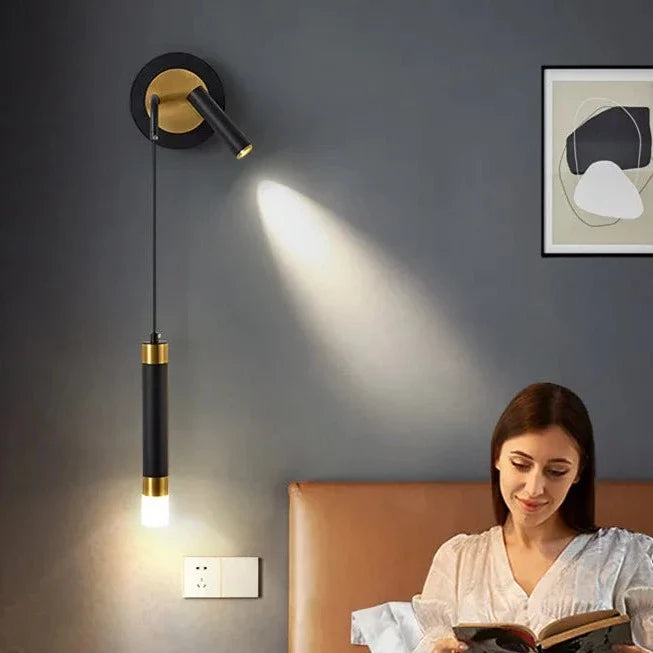 Bold gold wall lamp with integrated reading light and warm white LED lighting, stylish and modern for interior decor.