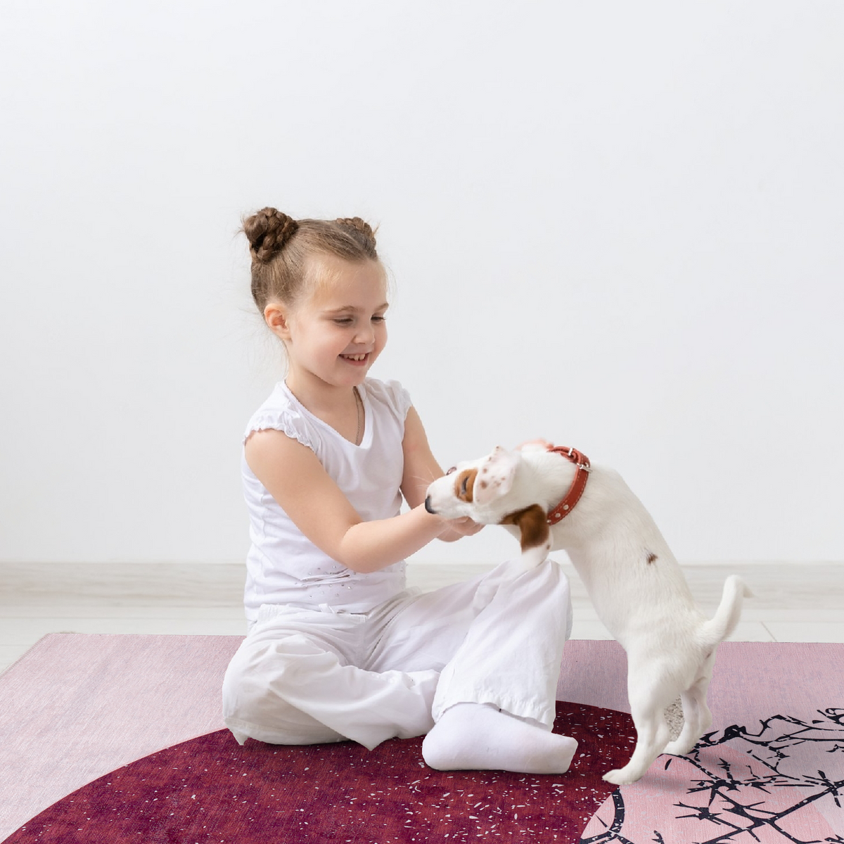 Kids and pet playing on a black and white geometric patchwork washable rug by Netline Home with playful design.