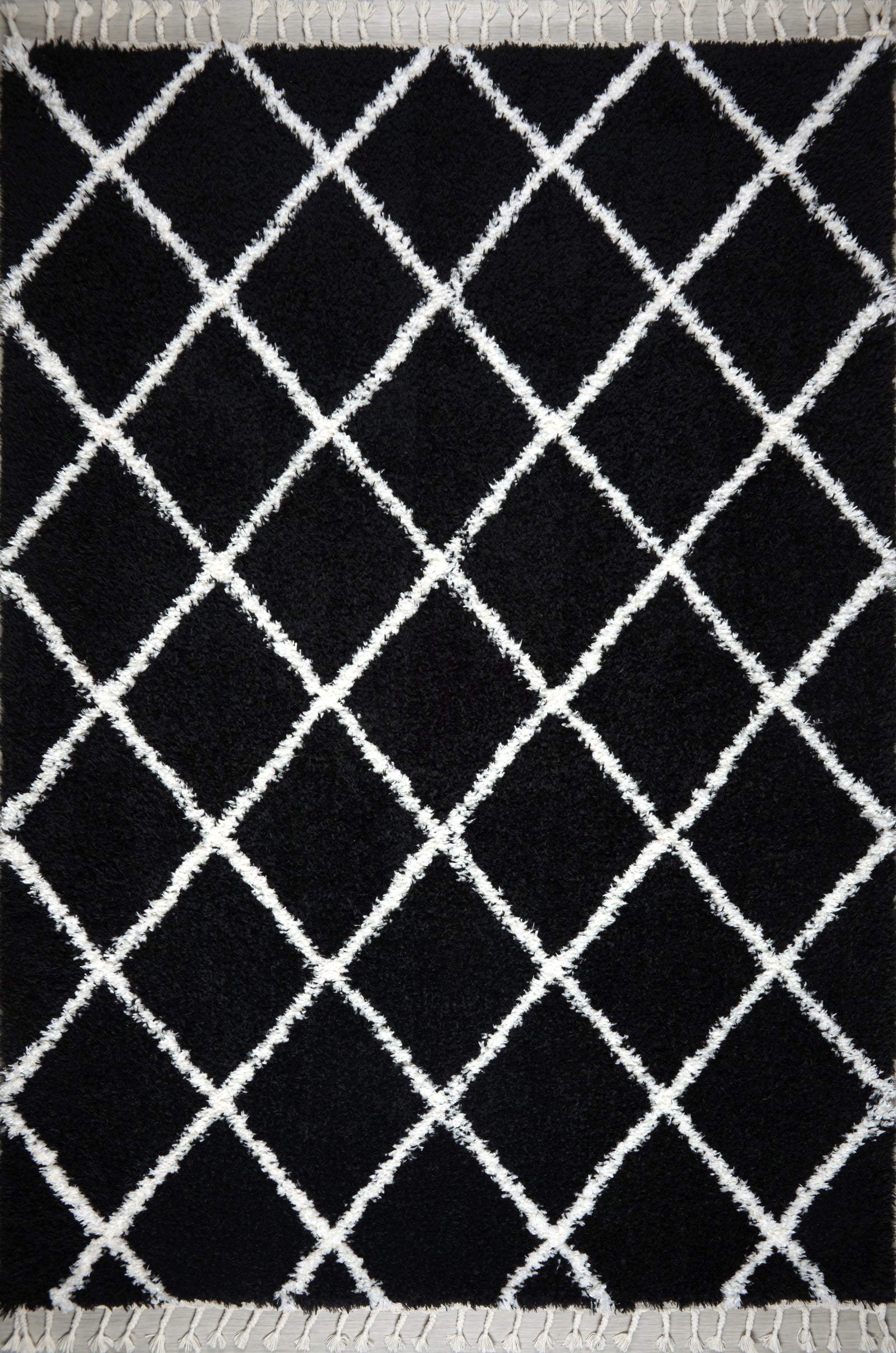 Black and white shaggy Moroccan rug with diamond pattern, high pile plush texture, and tassels by Netline Home.