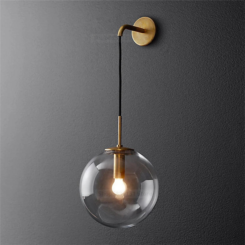 Mid-century glass globe wall light by Light My House with amber, smoke, and clear glass, hanging on a wall.