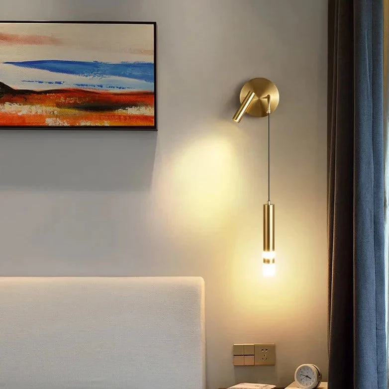 Bold gold wall lamp with built-in reading light and warm white LED lighting, modern design for bedroom or living room decor.