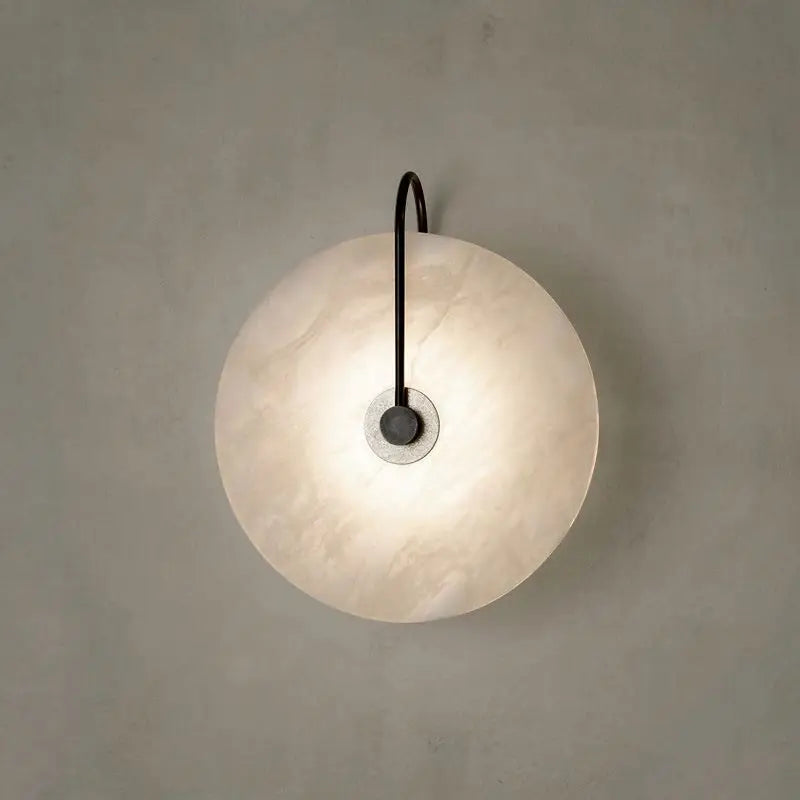 Modern marble wall lamp with disc texture, emitting warm LED light, ideal for contemporary home decor by Light My House.