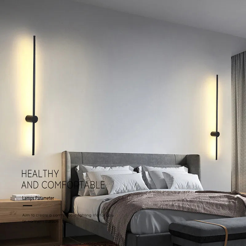 Black LED wall light by Light My House, warm modern bedroom lounge lamp with easy installation, mounted on a neutral wall.
