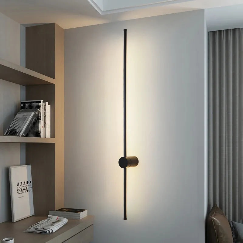 Black LED wall light by Light My House, modern warm-toned bedroom lounge lamp with easy installation, mounted on a wall.