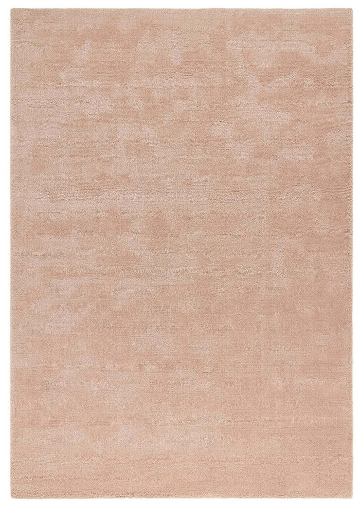 Hush Solid Coral Pink Luxury Rug shown in an illustrative room