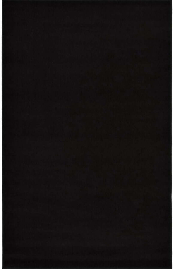 Maestro Solid Black Rug shown in an illustrative room