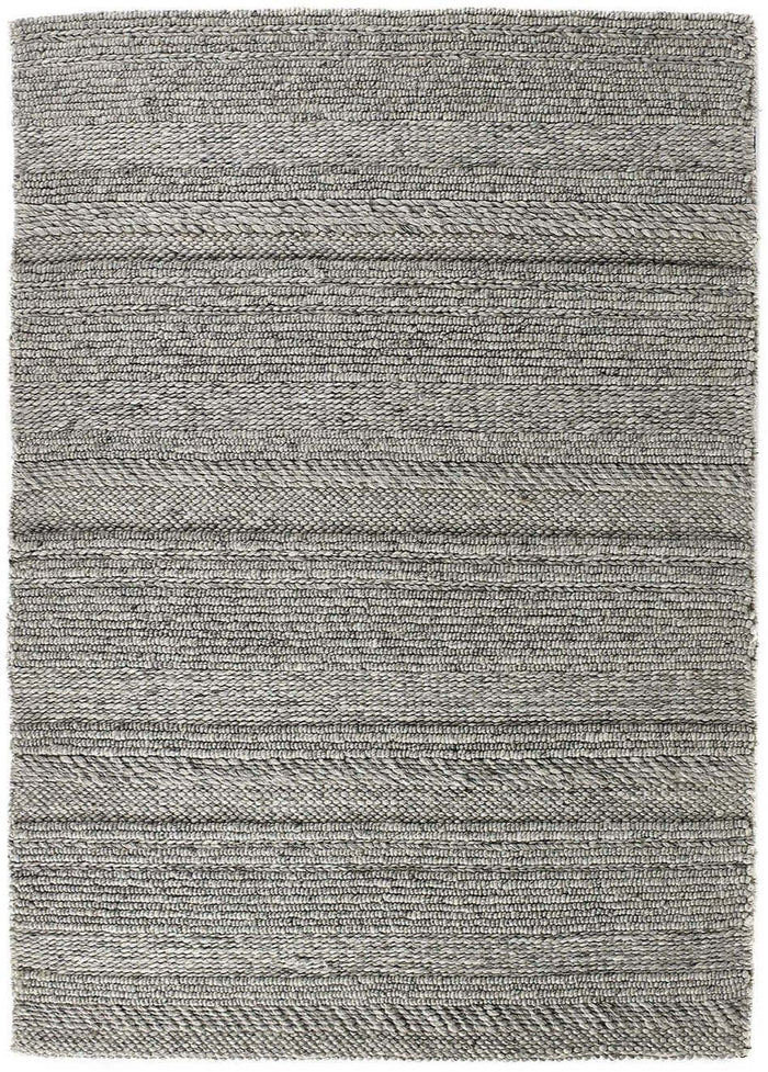 Chunky Natural/Grey Knitted Rug shown in an illustrative room