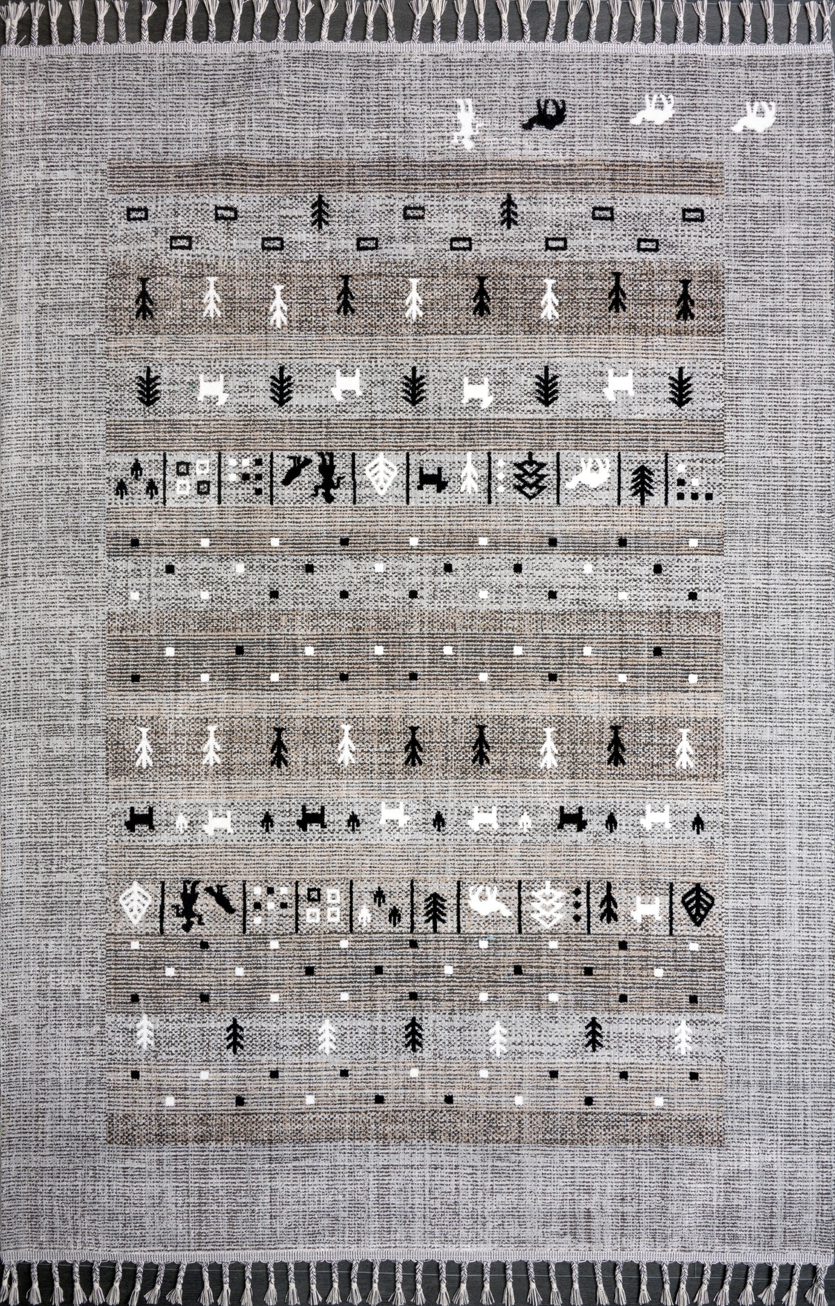 Gray and black tribal flatweave indoor outdoor rug with geometric pattern and tassels by Netline Home, suitable for versatile spaces.