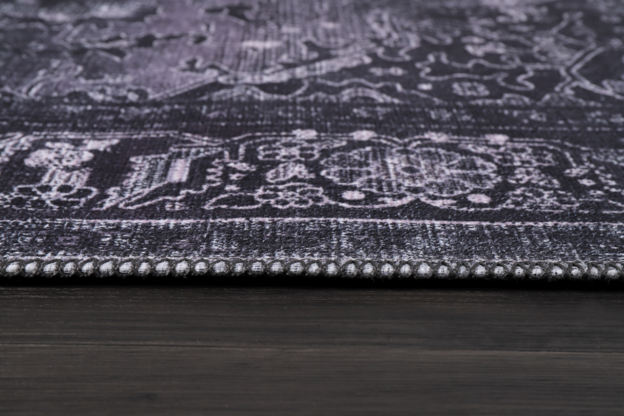Black geometric medallion washable rug by Netline Home with tribal patterns, featuring bold shapes and intricate design details.