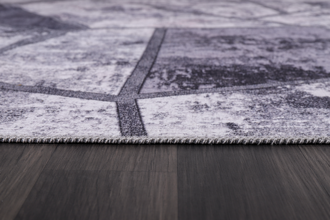 Black and white geometric patchwork washable rug by Netline Home featuring modern design and bold pattern.