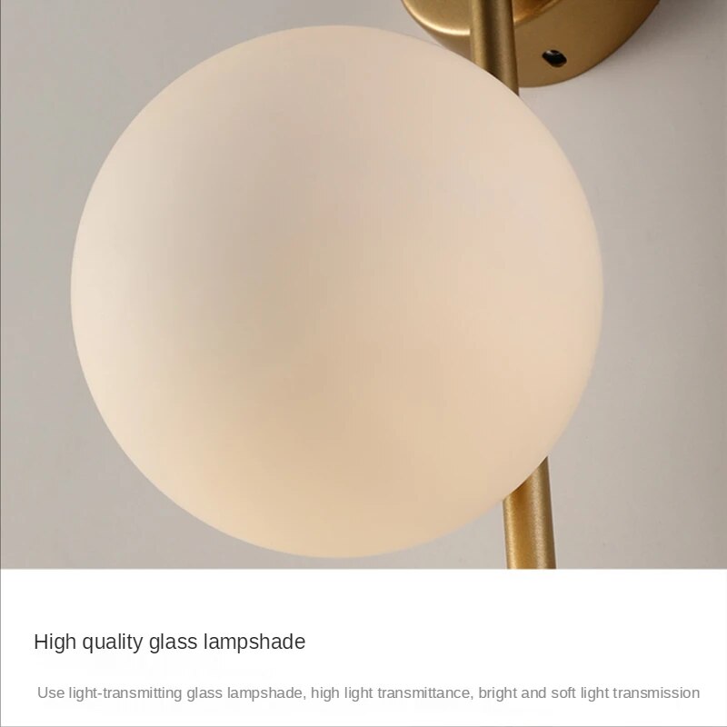 Gold globe wall lamp by Light My House, luxurious bedroom and living room light fixture with a spherical design and warm gold finish.