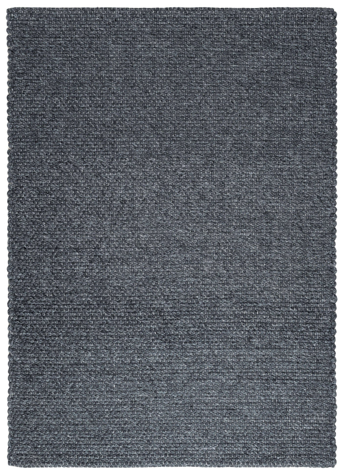 Solid Design Low Pile Eco Charcoal Rug shown in an illustrative room