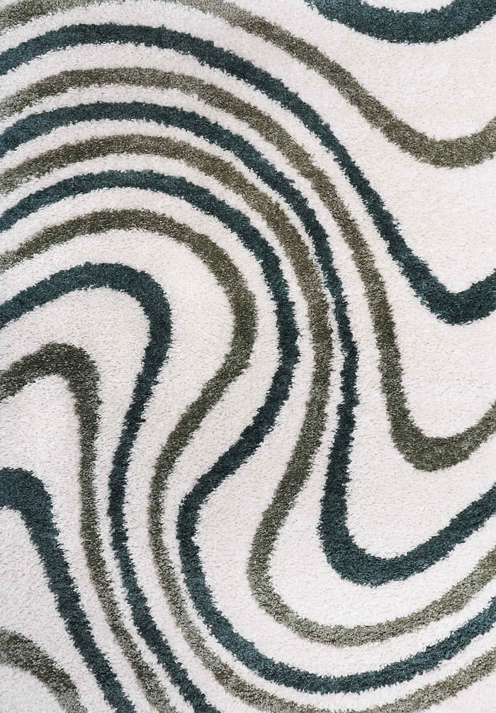 Moodi Shaggy Green Rippletide Rug shown in an illustrative room