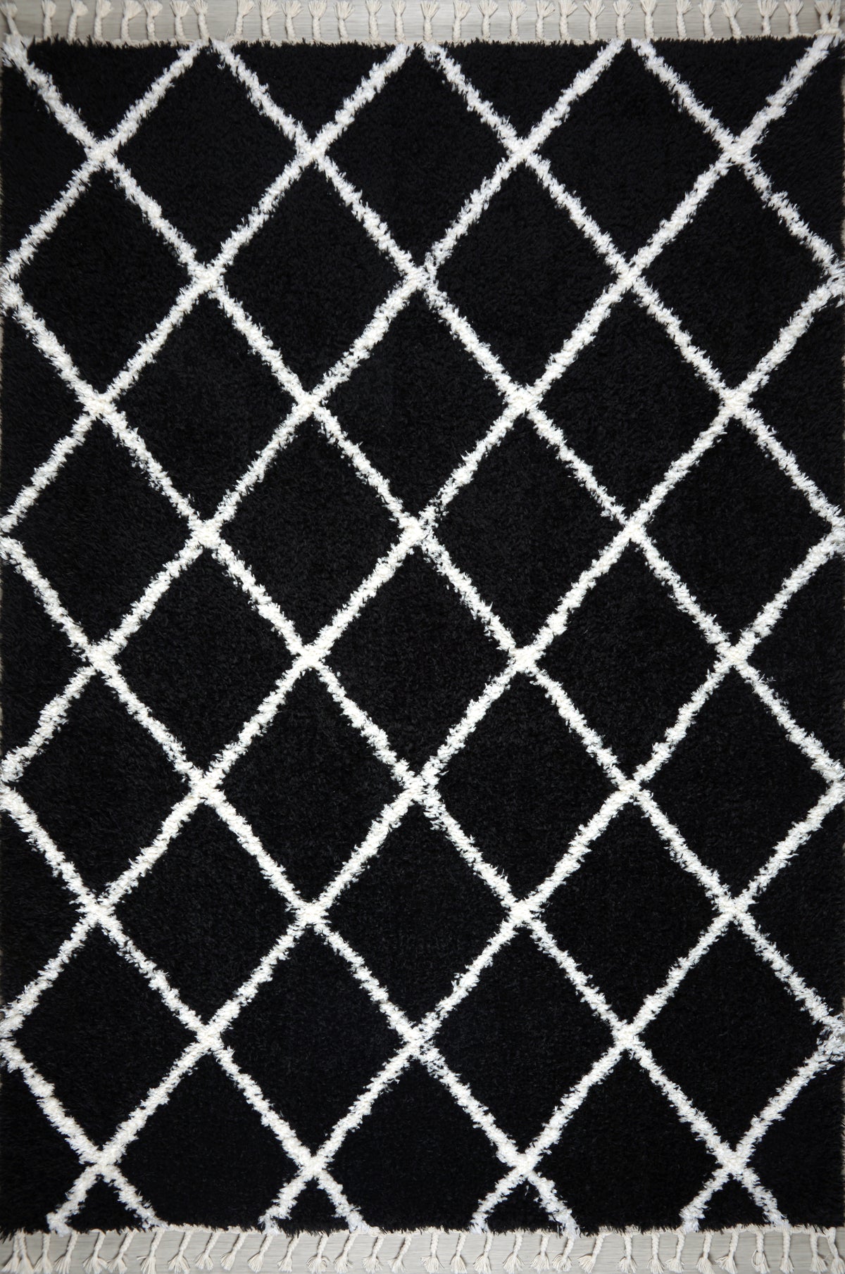 Black and white shaggy Moroccan rug with diamond pattern, high pile plush texture, and tassels by Netline Home.