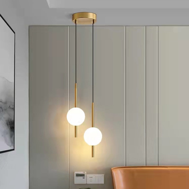 Modern dual globe pendant light by Light My House with changeable colors, installed in a bedroom ceiling.