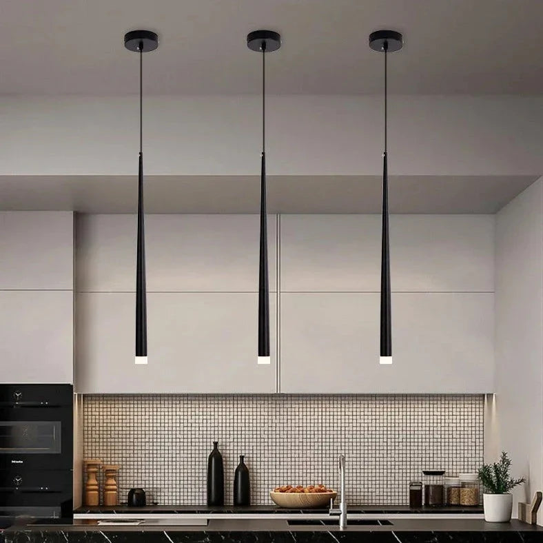Sleek Drop Pendant Light by Light My House with adjustable height and warm LED illumination, hanging from a ceiling.