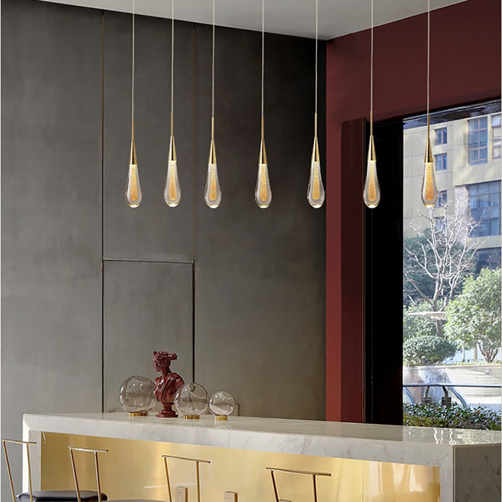 Glass Drop Pendant Light by Light My House featuring a warm LED bulb hanging on a string for ambient lighting.