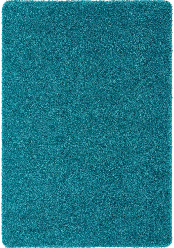 Washable Teal Shaggy Rug shown in an illustrative room