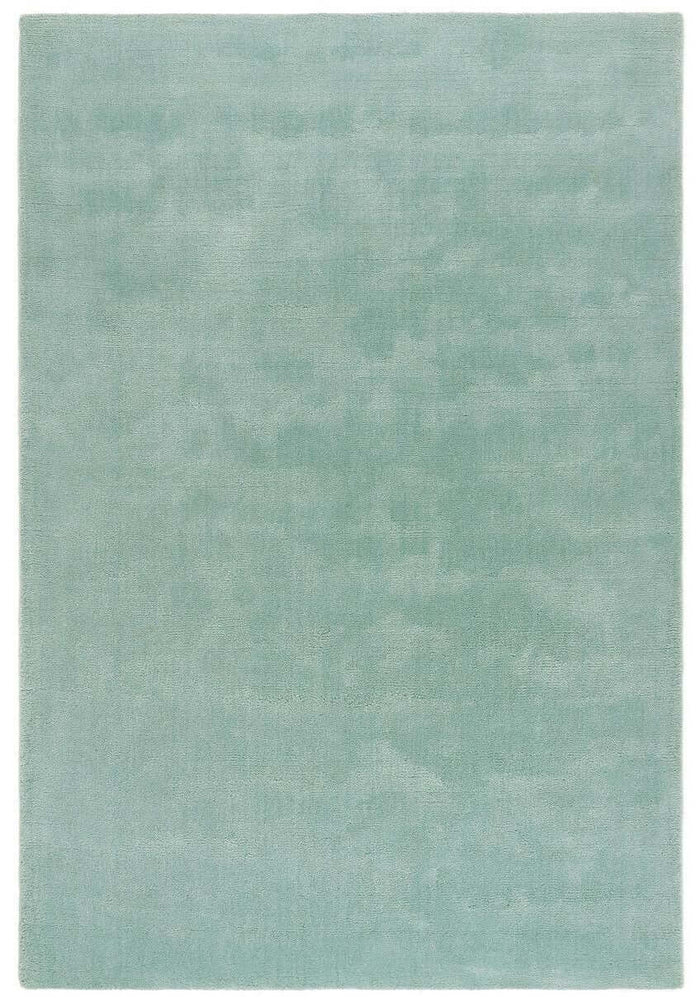 Hush Solid Aqua Luxury Rug shown in an illustrative room