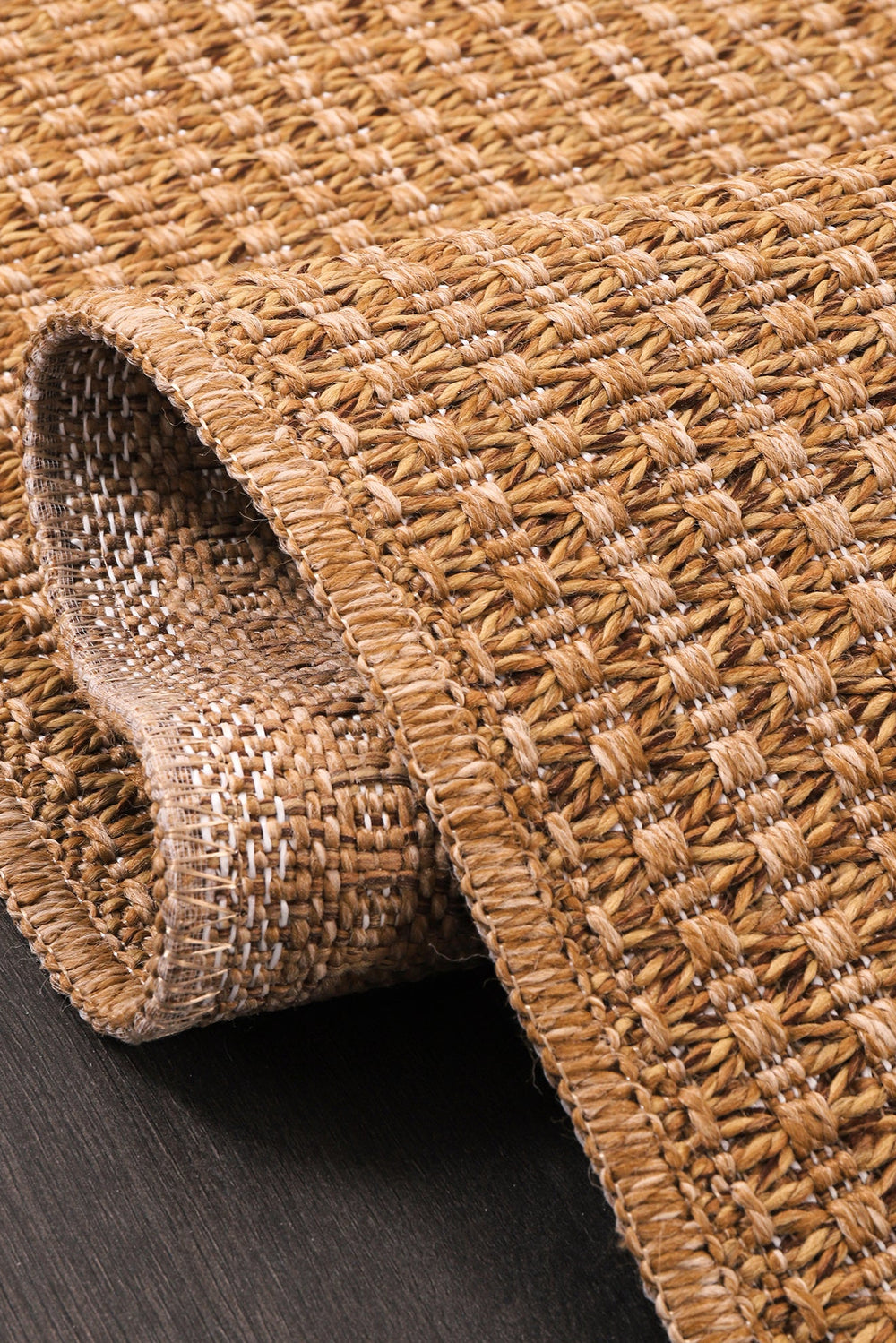 Close-up of Netline Home Basket Weave Jute-Effect Washable Rug showing woven texture and non-slip backing for indoor or outdoor use.