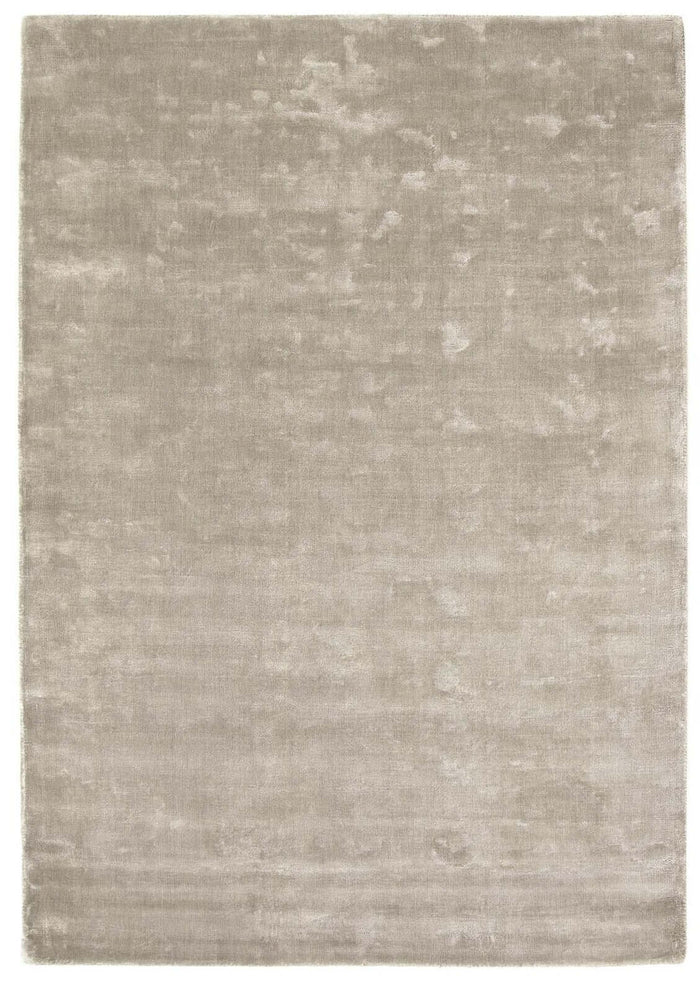 Karma Grey Solid Luxury Viscose Rug shown in an illustrative room