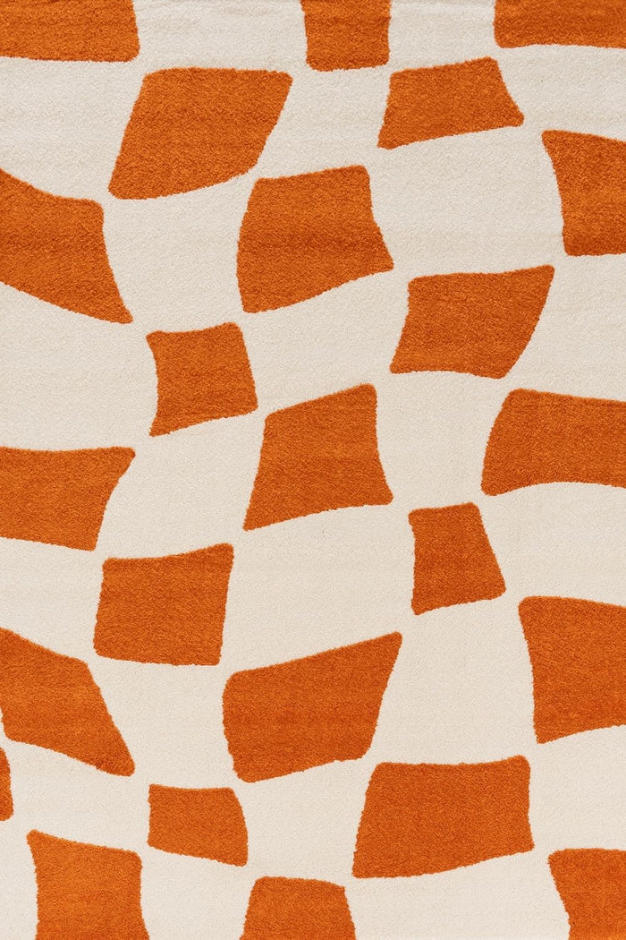 Joli Checkered Orange & White Rug shown in an illustrative room